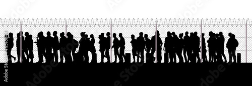 Refugees and immigrants looking for a new life. Column of migrants near the state borders. Fence and barbed wire. Surveillance, supervised. Abandon their lands for a better future. Silhouette