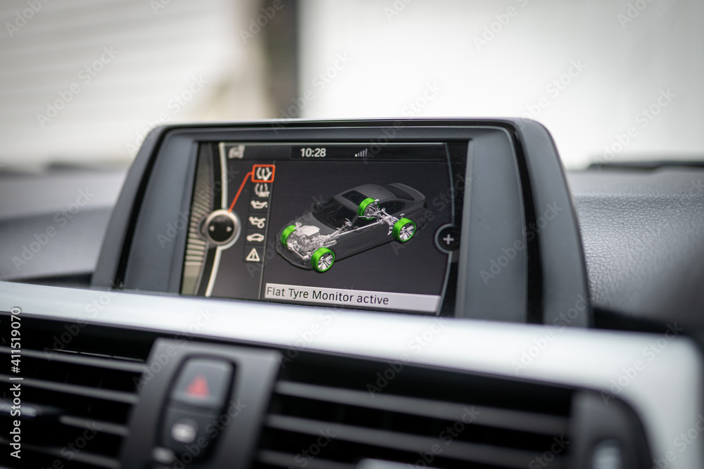 Car tyre pressure safety monitoring system for run flat wheels displayed on colour vehicle entertainment screen display showing green with no faults Car tyre pressure safety monitoring system for run flat wheels displayed on colour vehicle entertainment screen display showing green with no faults