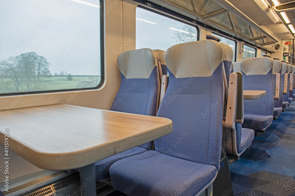 Fototapeta premium Interior of an empty commuter train carriage with seats
