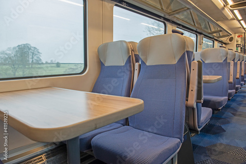 Interior of an empty commuter train carriage with seats