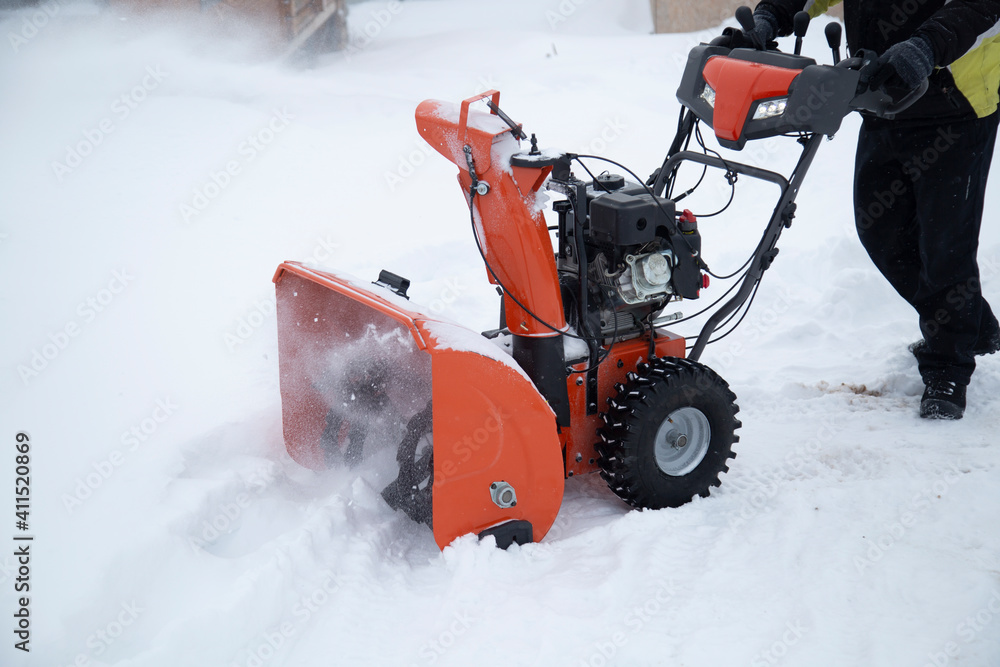 A portable snow blower powered by gasoline. Snow removal in winter. Stock  Photo | Adobe Stock