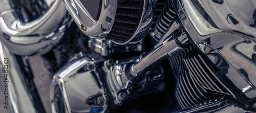 Selective focus on a motorcycle engine. Shiny chrome motorbike engine detail. Vintage motorbike. Closeup motorcycle air filter. Motorcycle industry.
