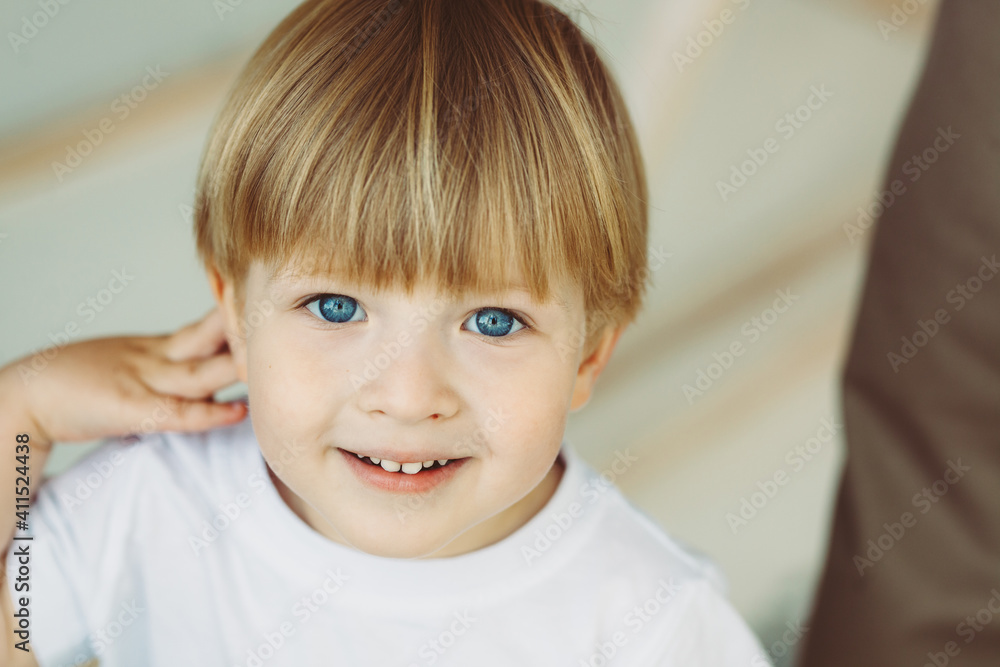 close portrait of cute smiling 3 year old blond boy with blue eyes wearing white t-shirt close portrait of cute smiling 3 year old blond boy with blue eyes wearing white t-shirt