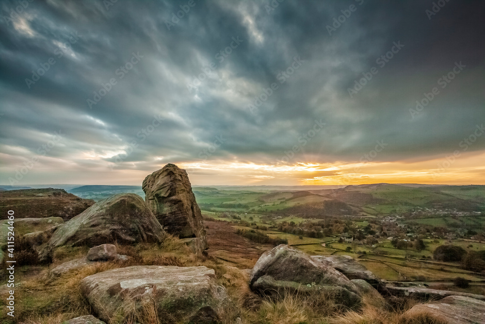 Sunset with moody clouds over Curbar Edge, Derbyshire, England