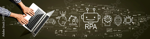 Fototapeta Naklejka Na Ścianę i Meble -  Robotic Process Automation RPA theme with person using a laptop computer
