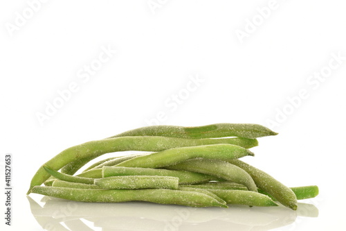 Frozen organic green beans, close-up, isolated on white.
