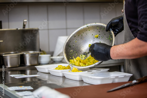 Fototapeta Naklejka Na Ścianę i Meble -  Chef preparing takeaway dish in the restaurant or pub , food delivery concept, home delivery, online order