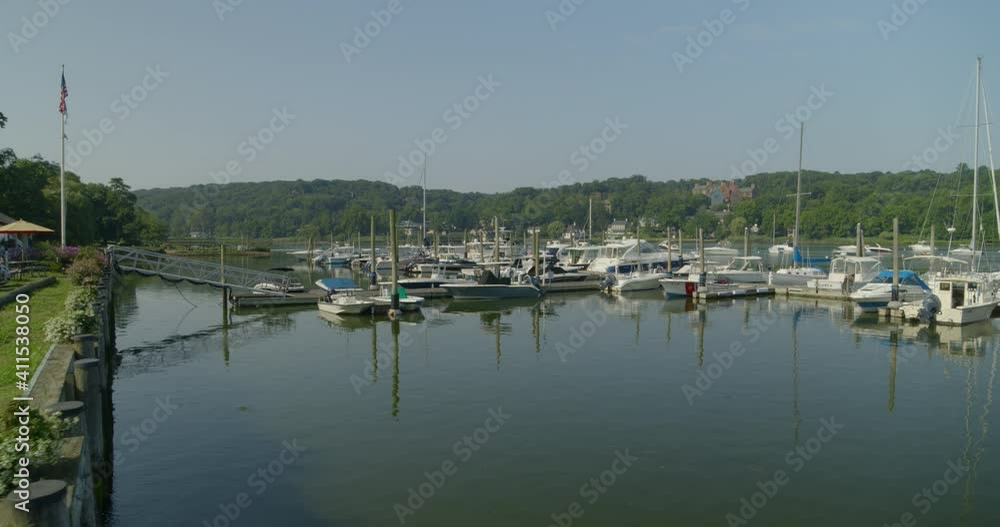 Flying Past a Caucasian Couple and Towards Boats Docked at a Marina Flying Past a Caucasian Couple and Towards Boats Docked at a Marina