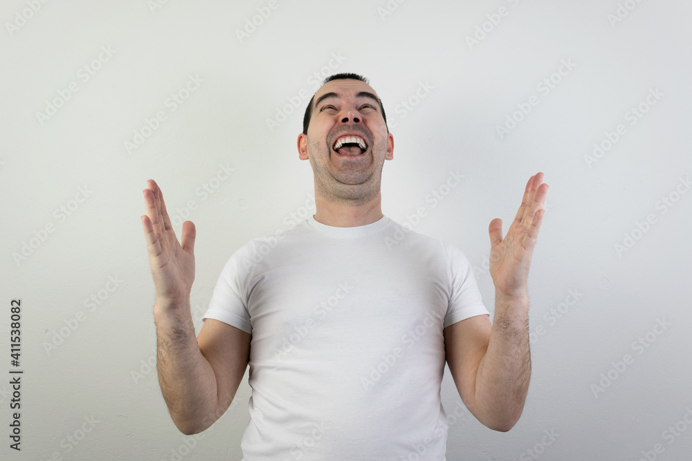 happy excited young man stand white background laugh hands up crazy look angry happy excited young man stand white background laugh hands up crazy look angry