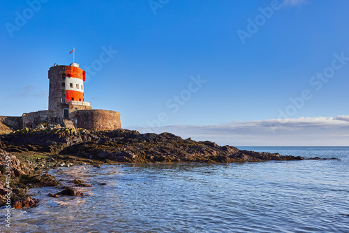 Image of Archirondel Bay with the Napoleonic Jersey Tower early on a sunny day. Jersey, Channel Islands