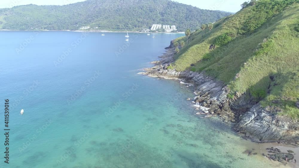 Top down aerial view of the tropical sea with wave crashing against an empty stone rocks cliff from above in clear ocean Open Sea. beautiful sea surface aerial view in the morning,High angle view Top down aerial view of the tropical sea with wave crashing against an empty stone rocks cliff from above in clear ocean Open Sea. beautiful sea surface aerial view in the morning,High angle view