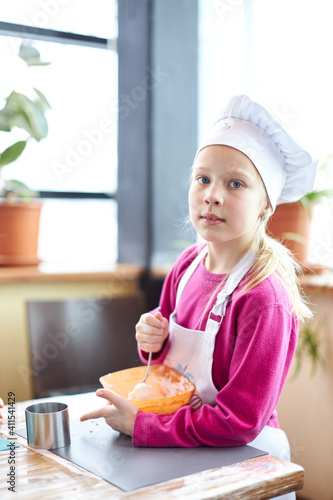 little girl writing in notebook