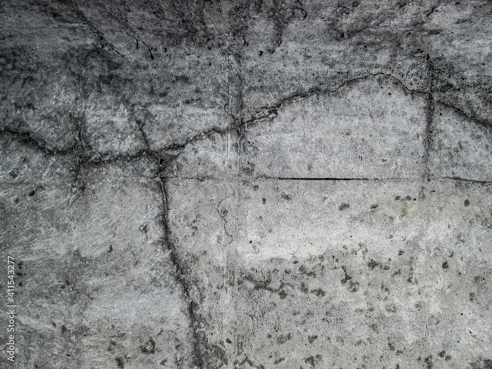 Obraz premium Cracks in a large, solid concrete slab. The effect of the destruction of a new building. Gray texture with damaged surface.