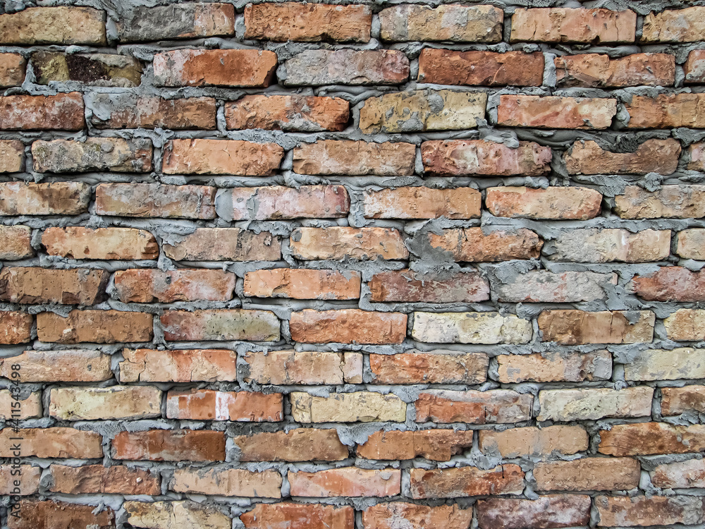 Fototapeta premium Simple brickwork with grooved stones. Stock photo of construction texture.