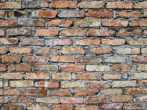 Simple brickwork with grooved stones. Stock photo of construction texture.