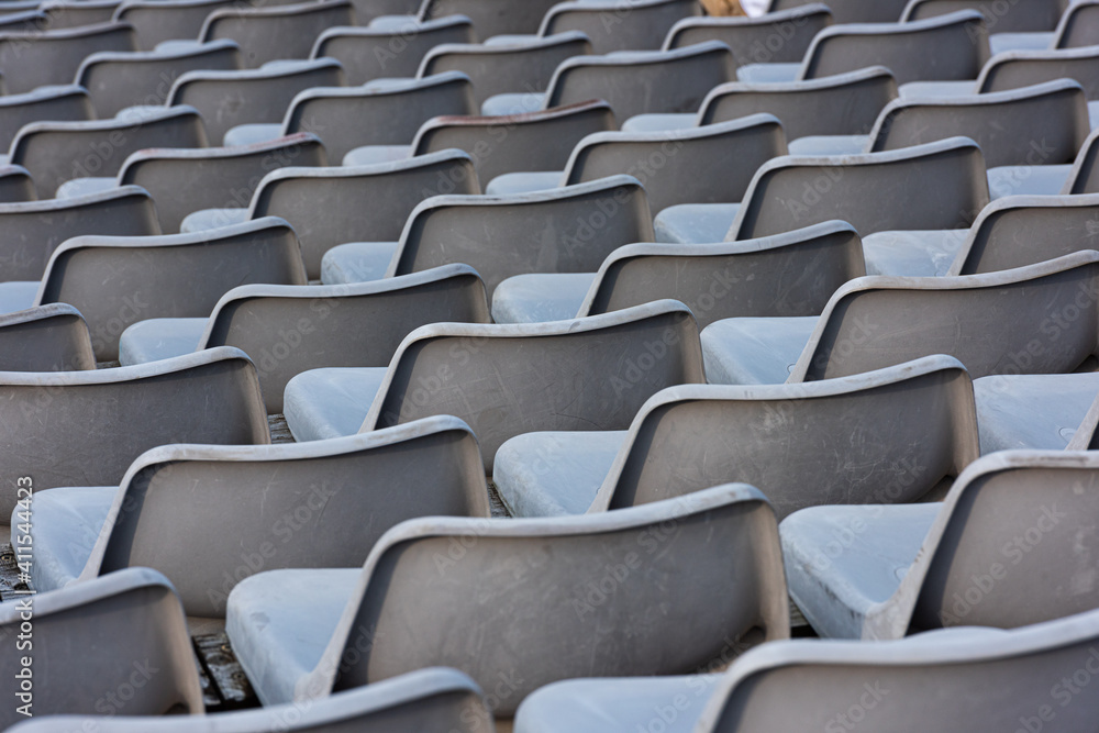 Empty grey seats on a seating tribune. Empty grey seats on a seating tribune.