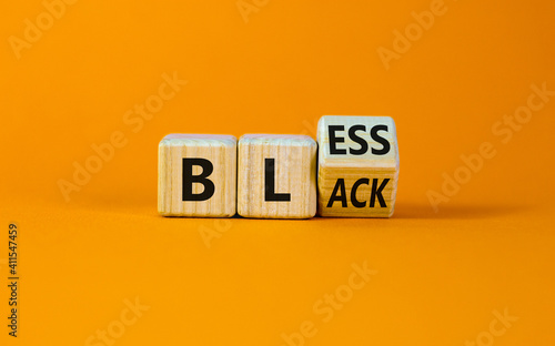 Bless black symbol. Turned a cube and changed the word 'black' to 'bless'. Beautiful orange background. Bless black concept. Copy space.