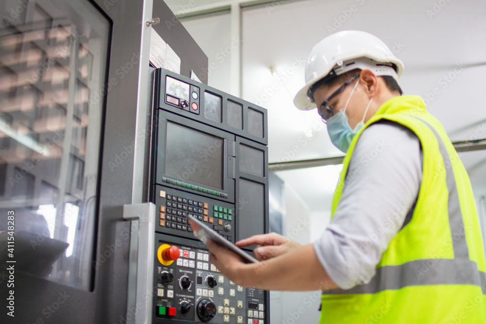 engineering working in factory concept.Selective focus Technician worker in manufacturing plant at machine control panel. Foreman engineer man wear safety helmet standing. engineering working in factory concept.Selective focus Technician worker in manufacturing plant at machine control panel. Foreman engineer man wear safety helmet standing.