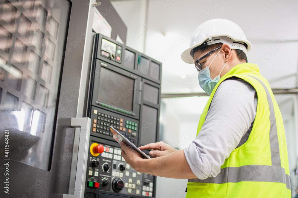 engineering working in factory concept.Selective focus Technician worker in manufacturing plant at machine control panel. Foreman engineer man wear safety helmet standing. engineering working in factory concept.Selective focus Technician worker in manufacturing plant at machine control panel. Foreman engineer man wear safety helmet standing.