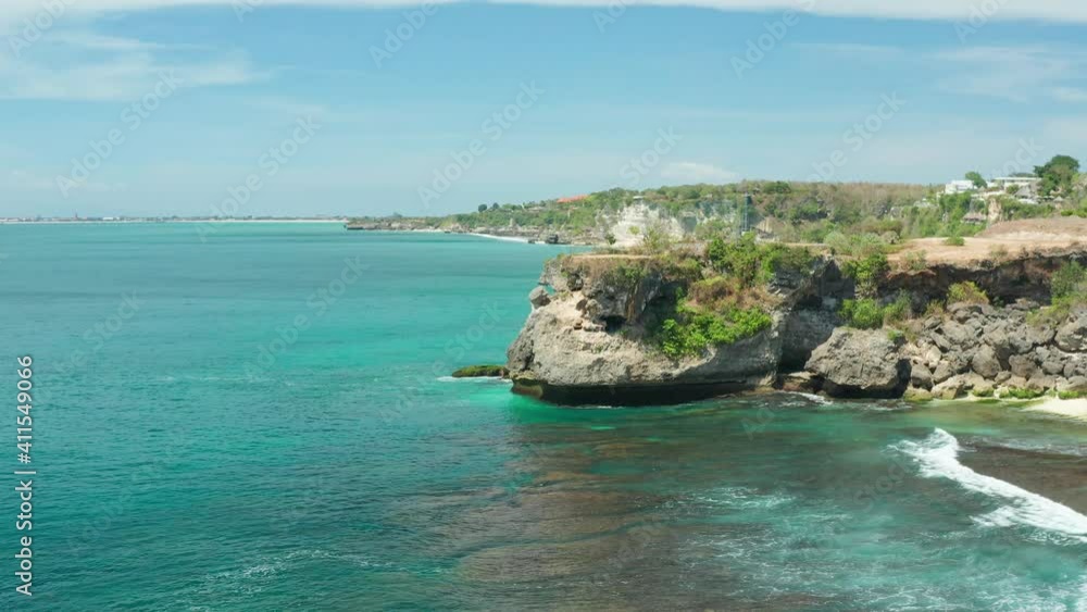 Beautiful view on Balangan beach Bali with azure sand beach, rocky mountains and clear sea water of Indian ocean at sunny day. Bali, Indonesia. 4K UHD Video Clip Beautiful view on Balangan beach Bali with azure sand beach, rocky mountains and clear sea water of Indian ocean at sunny day. Bali, Indonesia. 4K UHD Video Clip