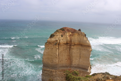 Limestone rocks appearing in water on a beach, Twelve Apostles