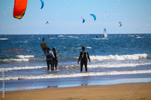 Instructor and students during kitesurf courses at the beach of the Atlantic ocean (Tenerife, Spain)