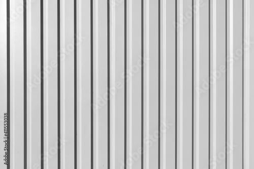 Galvanized Corrugated Silver Fence Material Surface. Grunge Grey Metal Wall or Roof Surface. Aluminum Siding Panel Profile.