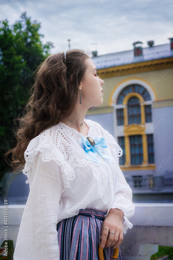 Portrait woman in vintage clothes on terrace of mansion