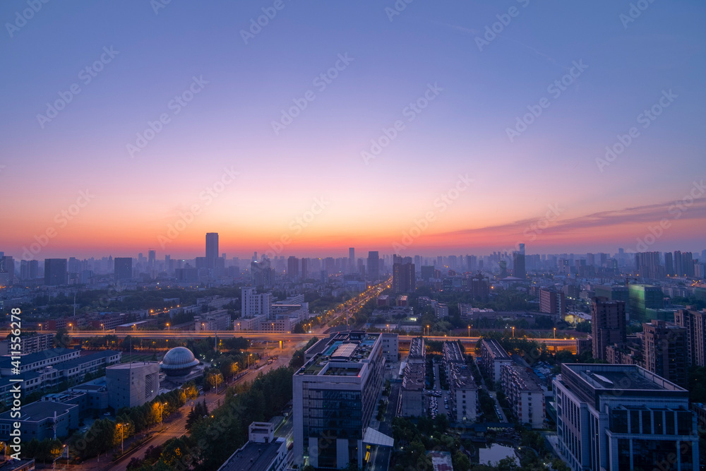 Aerial view of the city skyline at dawn.