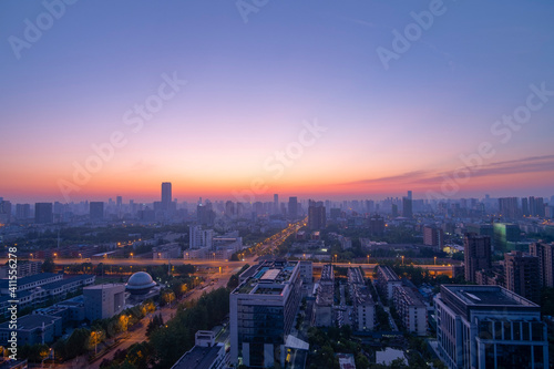 Aerial view of the city skyline at dawn.