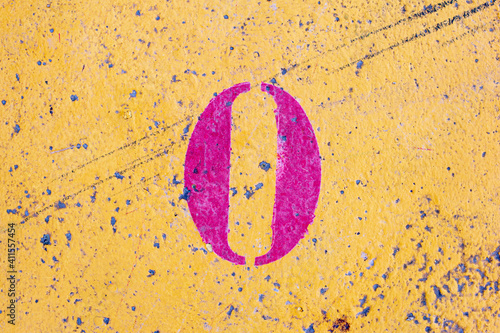 number 0 on a colored concrete floor