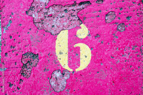 number 6 on a colored concrete floor
