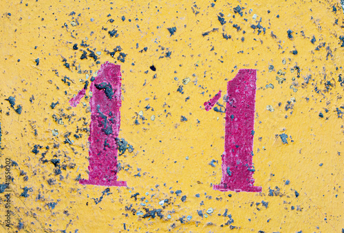 number 11 on a colored concrete floor
