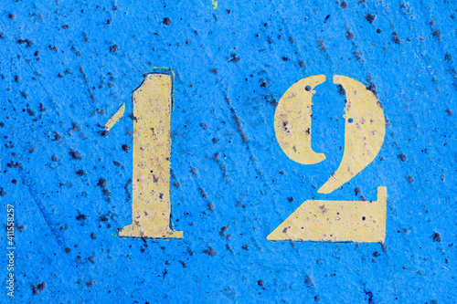 number 12 on a colored concrete floor