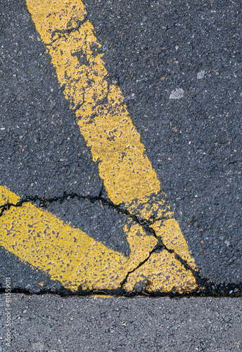 yellow road markings on grey asphalt
