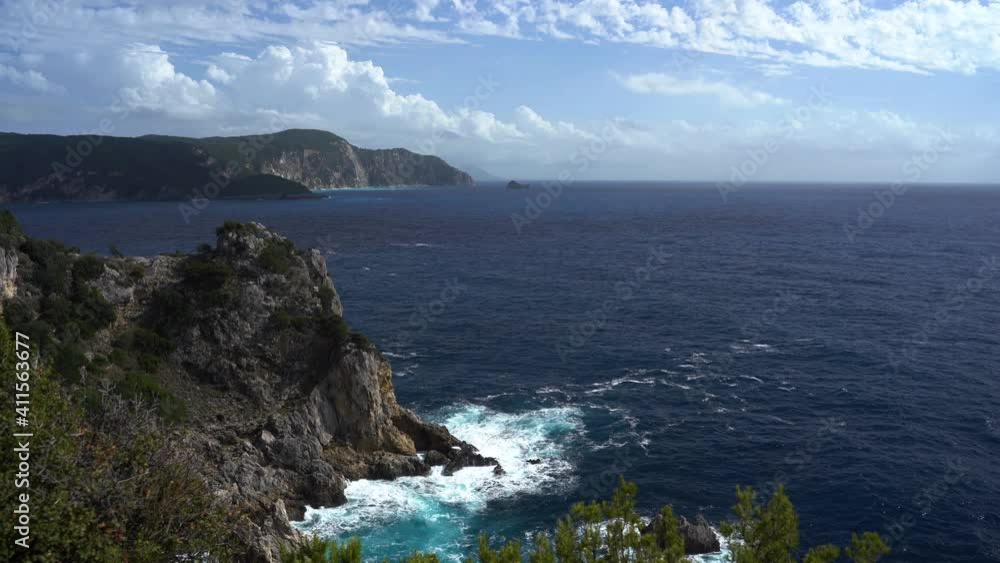 Greece island waves crashing into mountain cliff coastline beach Mediterranean Sea tropical destination