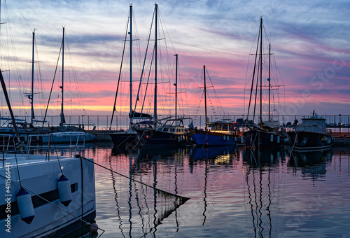 Various ships and boats in a marina of Thessaloniki, Greece at sunset