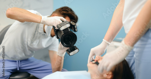 Dentist photographing with professional camera the result of his work. Patient with braces during orthodontic treatment. 4k video screenshot  please use in small size