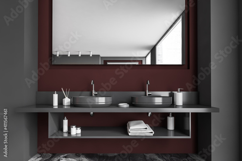 Concrete dark grey bathroom interior with a grey marble floor  a double sink.