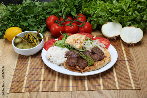 grilled meatball with rice pilaf and onion tomatoes