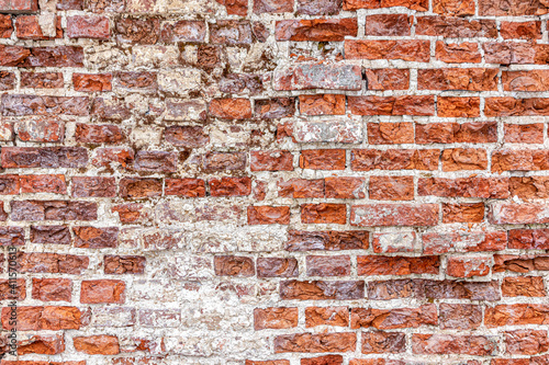 Old brick wall, with cracked and destroyed bricks