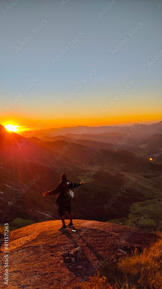 silhouette of a person on a mountain