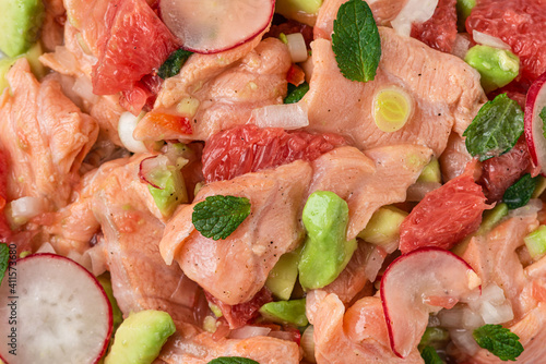 Salmon ceviche with grapefruit, avocado, radish, onion and mint. Healthy diet food. top view. close up