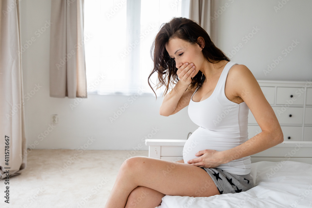 Pregnant woman holds hand on belly. Pregnancy, maternity, preparation and expectation concept. Close-up, copy space, indoors. Beautiful tender mood photo of pregnancy. Pregnant woman holds hand on belly. Pregnancy, maternity, preparation and expectation concept. Close-up, copy space, indoors. Beautiful tender mood photo of pregnancy.