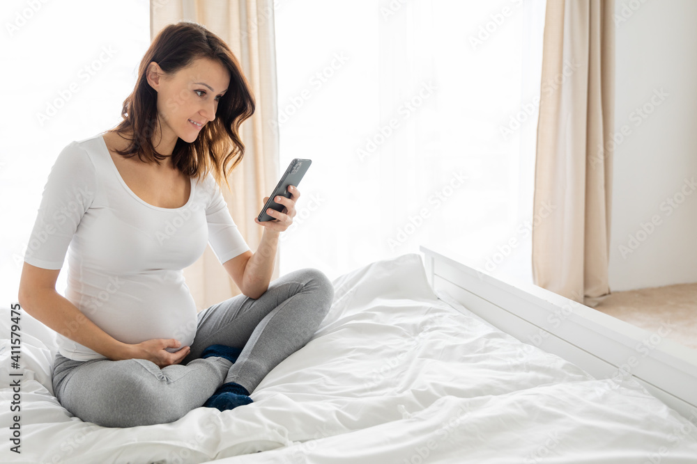 Pregnant woman holds hand on belly. Pregnancy, maternity, preparation and expectation concept. Close-up, copy space, indoors. Beautiful tender mood photo of pregnancy. Pregnant woman holds hand on belly. Pregnancy, maternity, preparation and expectation concept. Close-up, copy space, indoors. Beautiful tender mood photo of pregnancy.