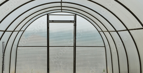 Empty greenhouse until spring with plastic structure