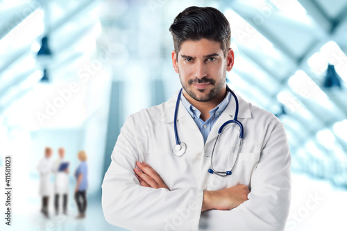 Male doctor portrait while standing on the hospital's foyer