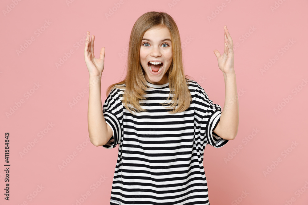 Little blonde stressed indignant angry kid nice girl 12-13 years old in striped oversized t-shirt spreading hands scream look camera isolated on pink background children. Childhood lifestyle concept. Little blonde stressed indignant angry kid nice girl 12-13 years old in striped oversized t-shirt spreading hands scream look camera isolated on pink background children. Childhood lifestyle concept.