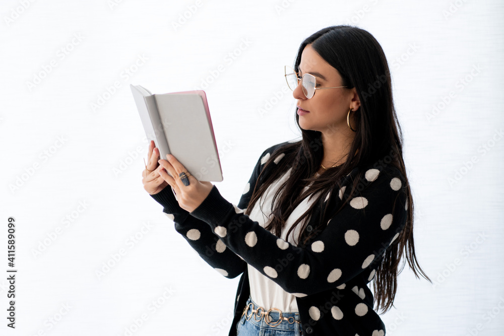 young woman reads a book on white background young woman reads a book on white background