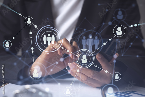 Businesswoman in formal wear checking the phone to sign the employment agreement to boost her career and gain new opportunities in personal growth. Concept of success. Social media hologram icons